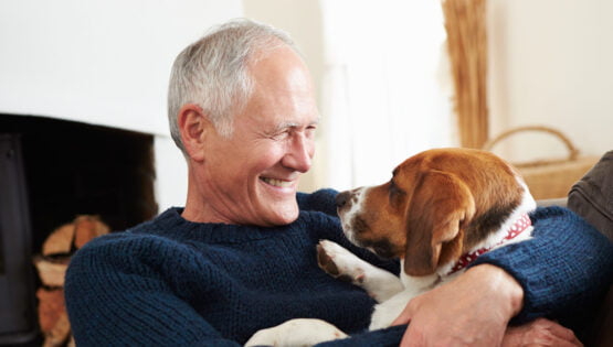 A man in his senior years with his dog