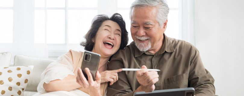 senior couple looking at iphone