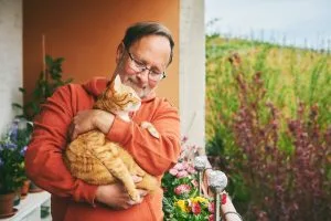 Happy older man with his cat