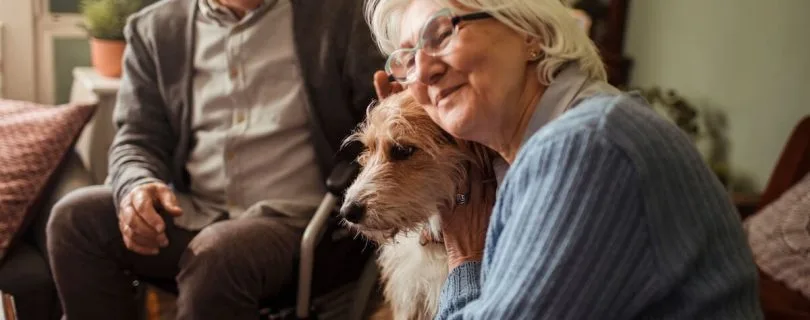 Happy older couple with their dog