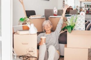 Relaxed woman sitting next to cardboard boxes