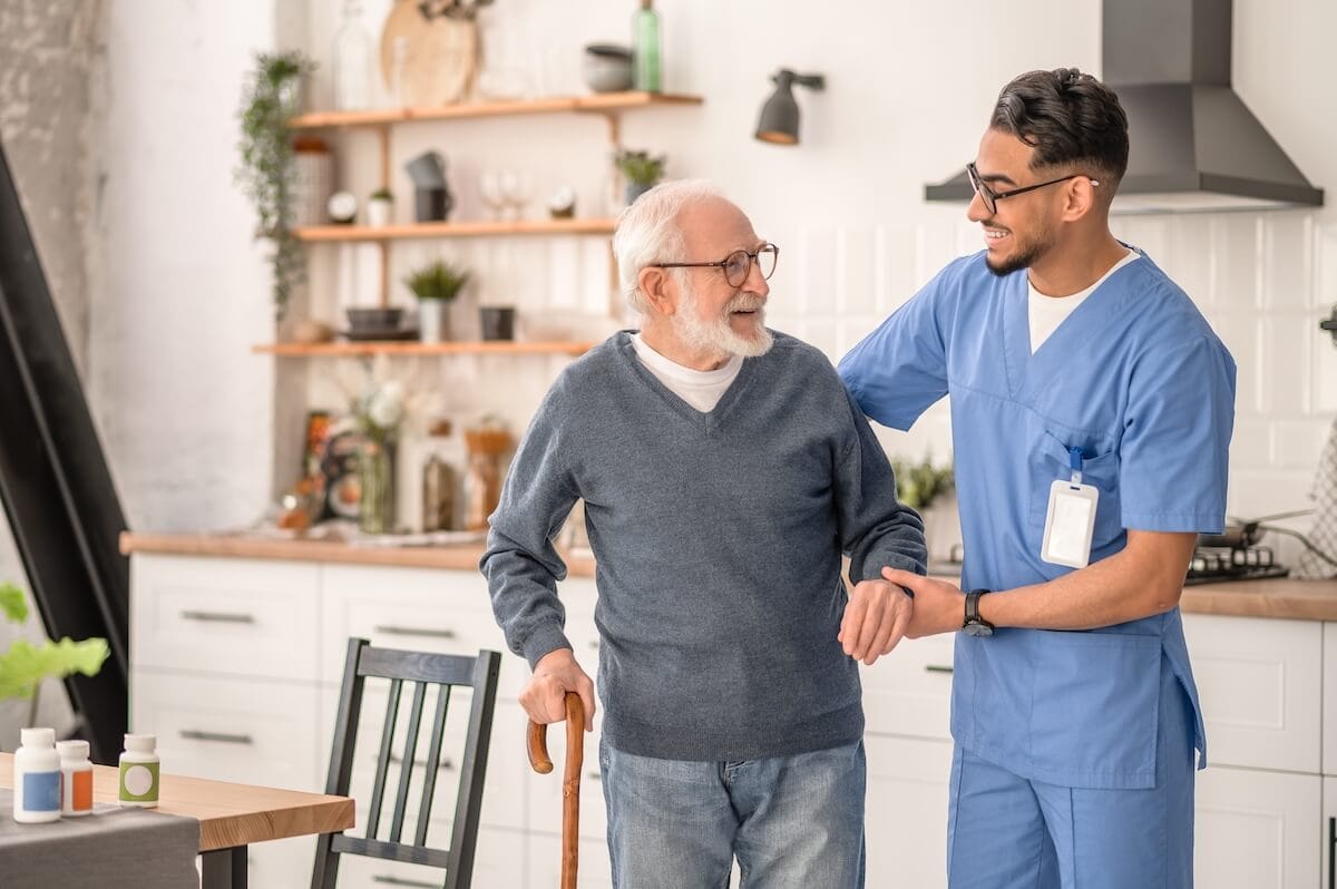 Caregiver helping an older adult to transfer