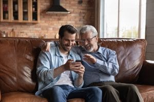 An adult son spending time with his elderly father