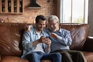 An adult son spending time with his elderly father