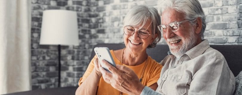 Senior couple communicating with their loved ones through a tablet
