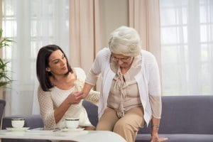Adult daughter helping her older mom with balance problems